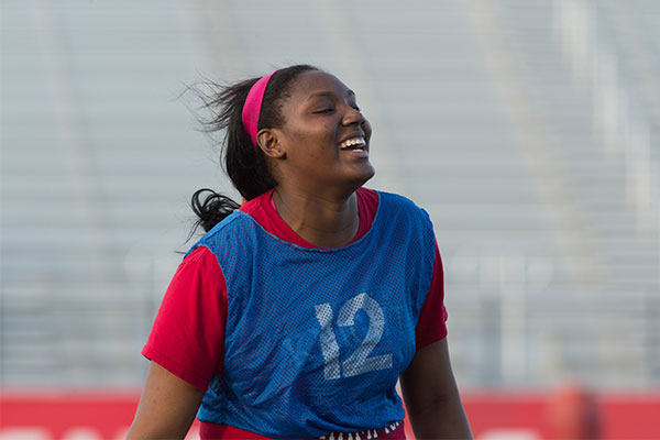 UIW Intramural Student Smiling while playing flag football