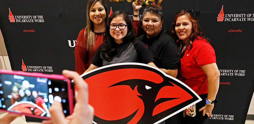 Group photo with UIW cardinal sign