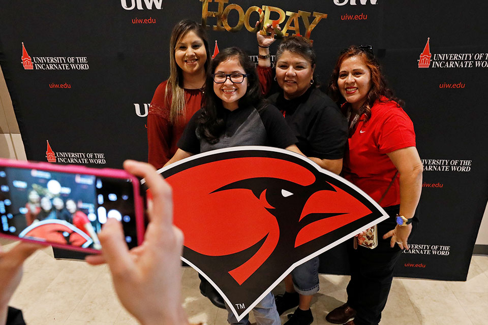 group taking photo with UIW logo