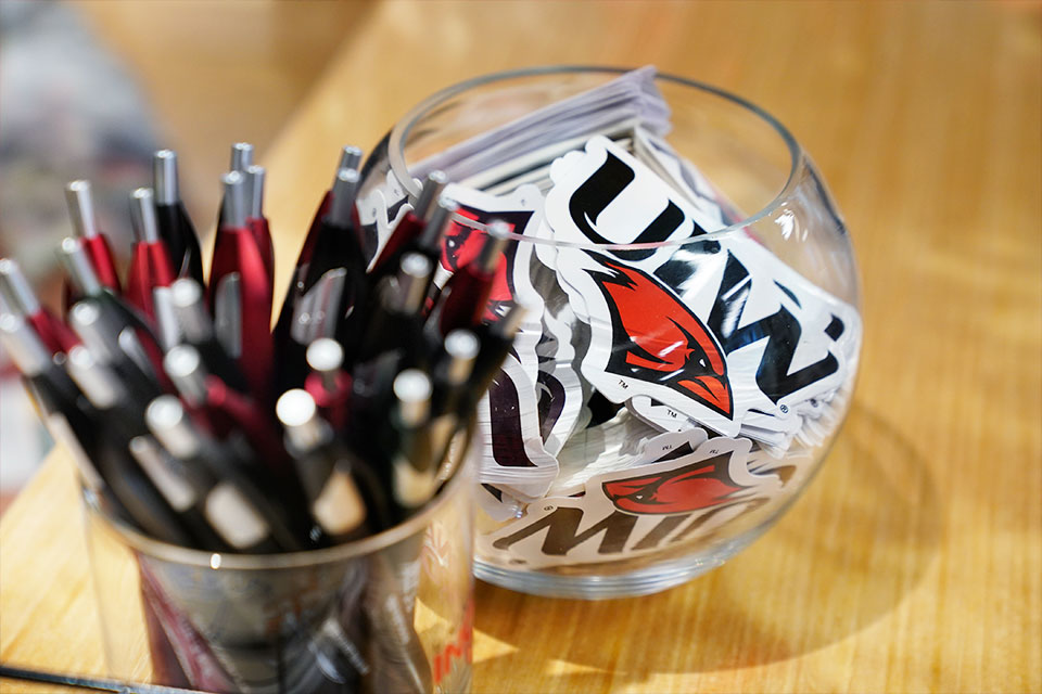 UIW pens and stickers in a clear jar